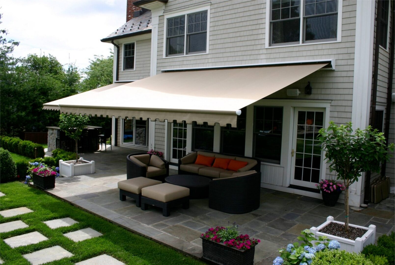 A patio with a couch and table outside of it