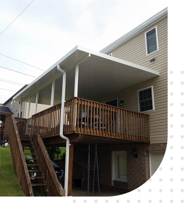 A house with a deck and stairs leading to the back of it.