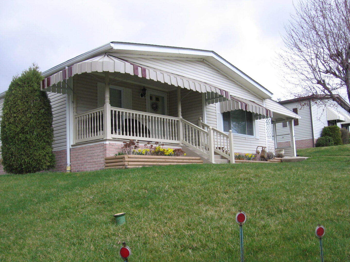 A house with a porch and awning on the front of it.